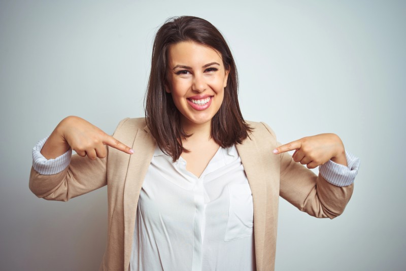 Photo of a businesswoman pointing at herself