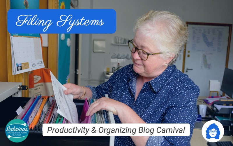 A photo of a woman retrieving a document from a filing cabinet. Depicting the Filing Systems edition of the Productivity & Organizing Blog Carnival, sponsored by Sabrina's Organizing & Admin Services
